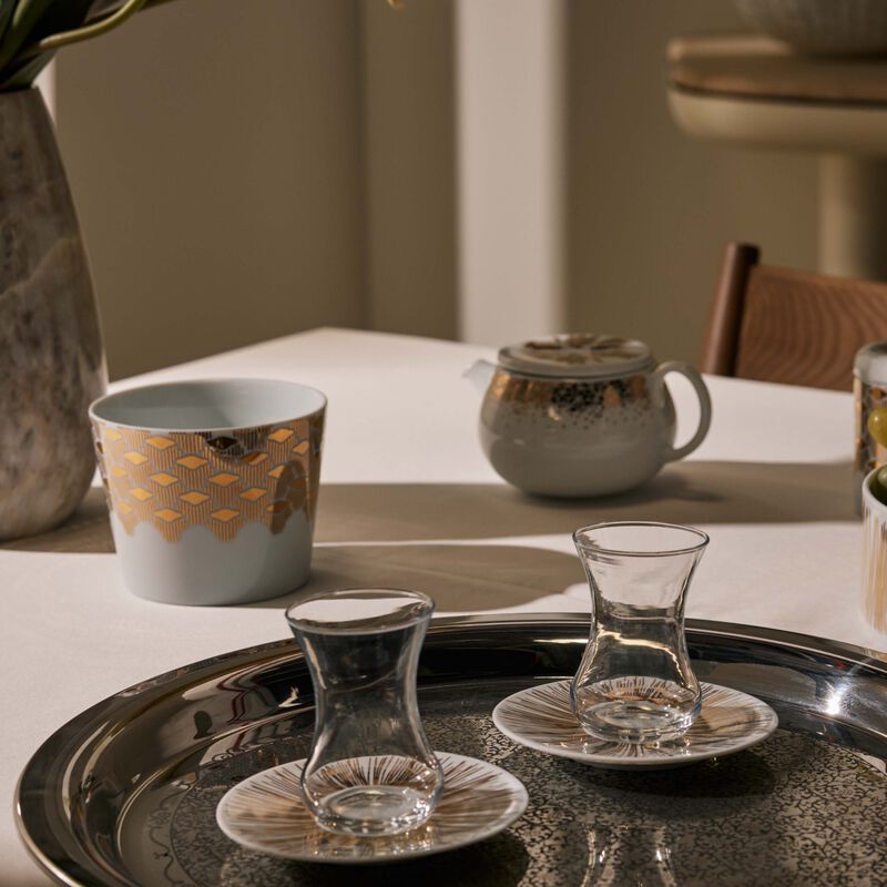 صلصال طقم تمرة بالتعاون مع رزان العزوني سترايبس المؤلف من فنجانين عربيين للشاي مع صحنيهما باللون الذهبي